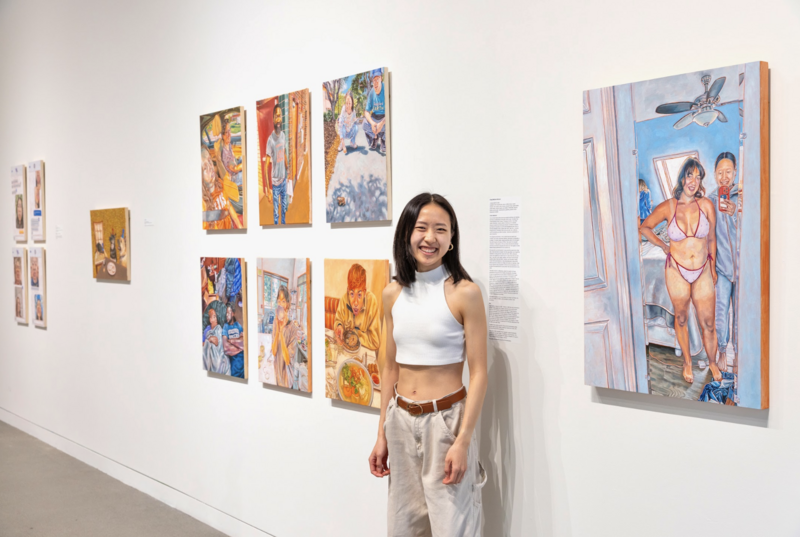 Painter Jackie Liu stands alongside work that celebrates small, radiant moments. She uses Artwork Archive to support her practice behind the scenes. Photo courtesy of the artist.